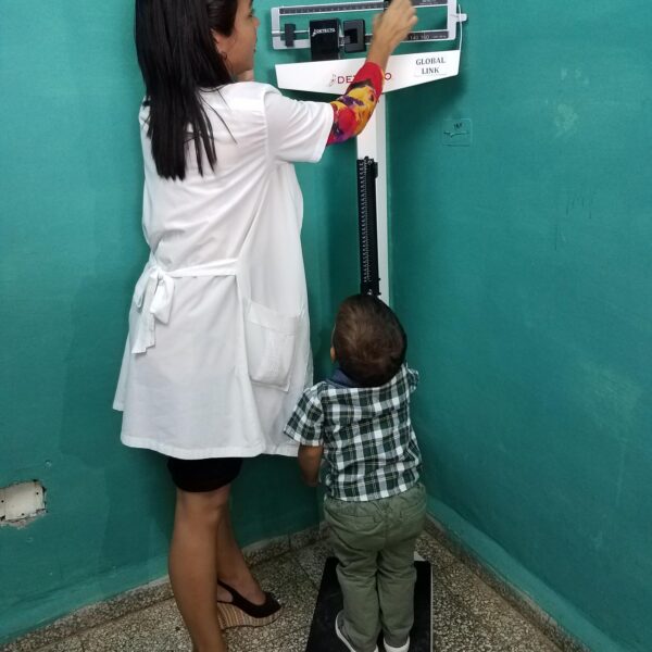 Doctor using the scale on a small child.