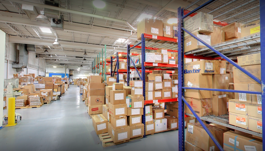 A large warehouse that has boxes stacked up on shelves